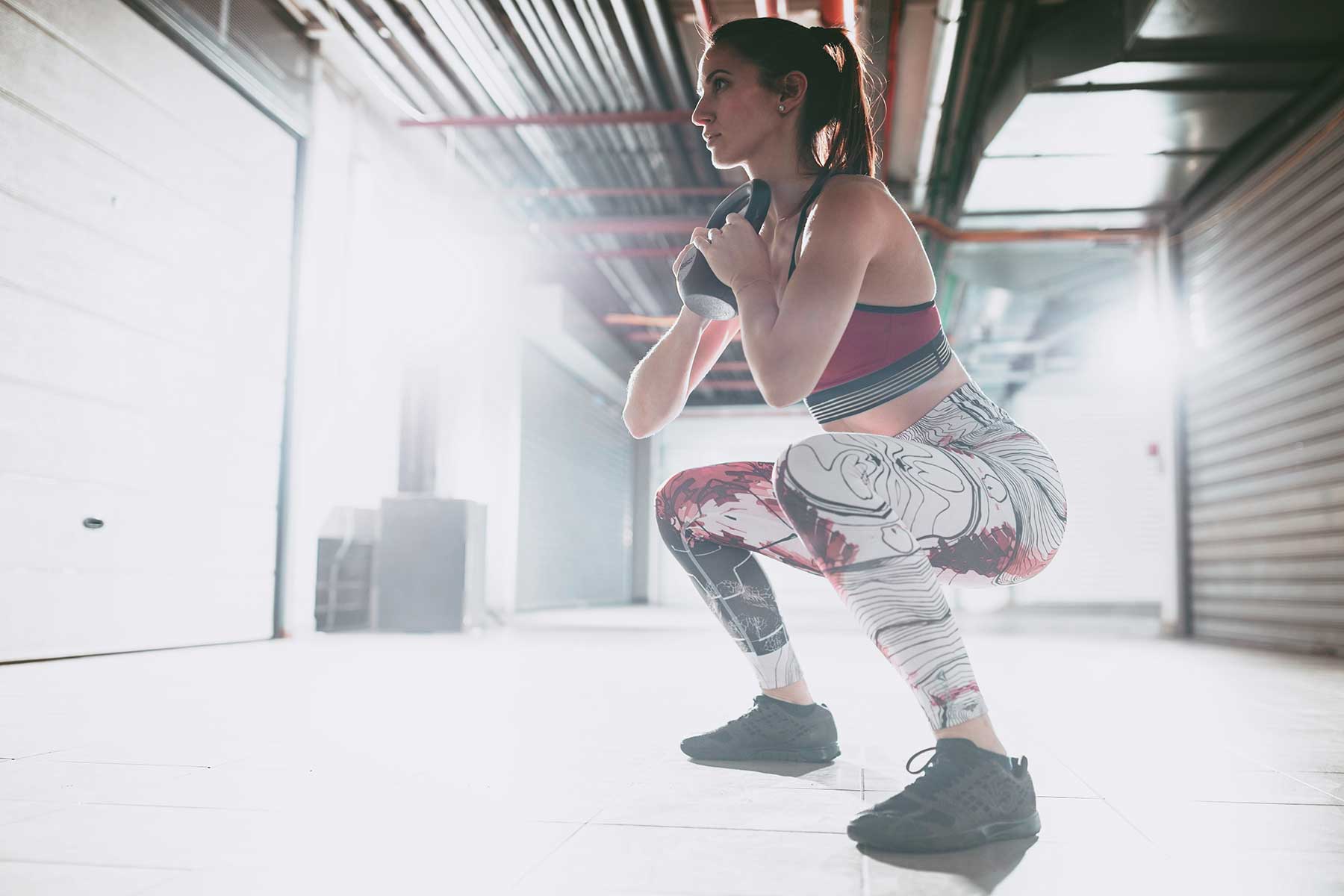 Woman doing a goblet squat in the gym